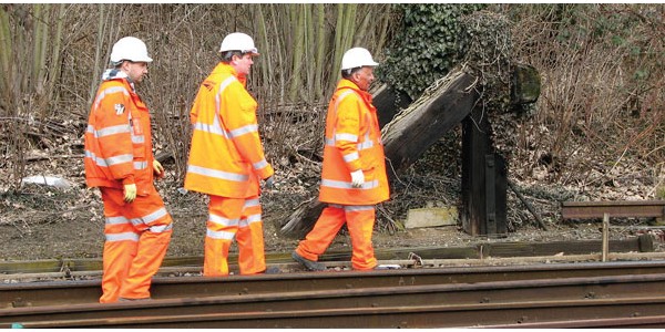 People in hi-vis on a railway tracks