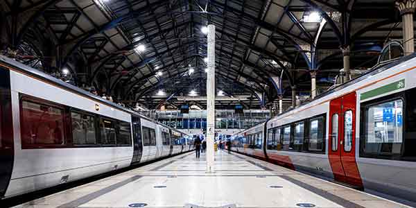 Two trains at train station at the end of a line