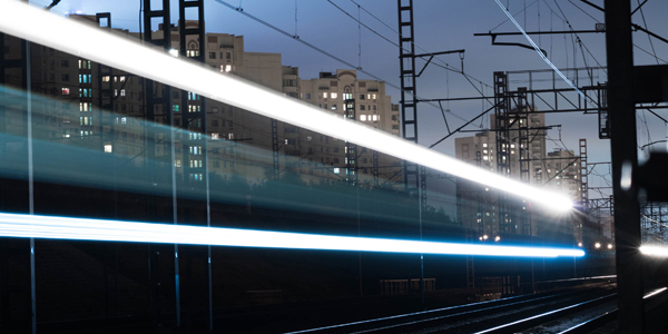 Moving train against city skyline