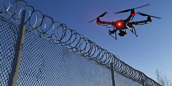 drone-filiming-high-security-fence