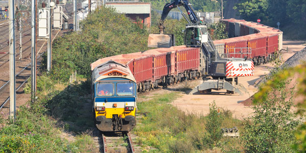 freight-train-running-through-field-promo-image