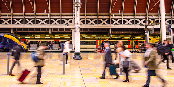 passengers-walking-on-covered-train-platform-blurred