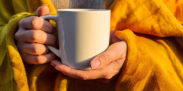 person-holding-hot-drink-promo