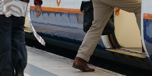 Platform train interface person stepping onto train from station platform