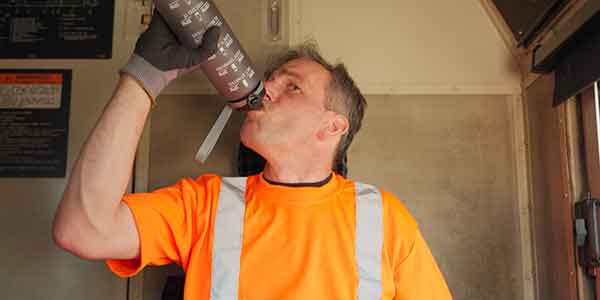 Frontline staff drinking water on hot day