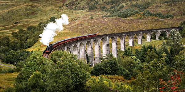 steam-train-crossing-bridge-countryside