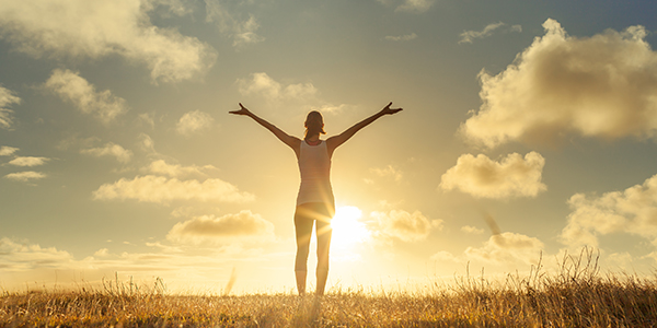 wellbeing-happy-person-with-arms-out-feeling-free-sunset-promo